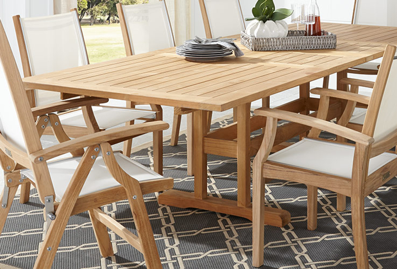 photo of teak dining table and chairs with ivory sling seats