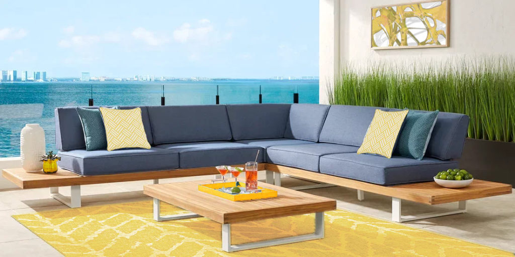 blue patio sectional with yellow decor accents