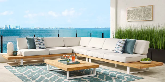 Modern terrace featuring white sectional and aqua accents.