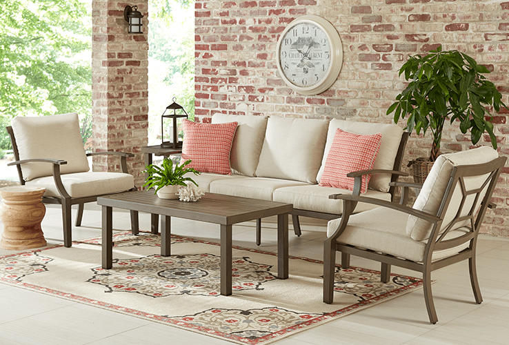 photo of a brown metal patio seating set with tan cushions