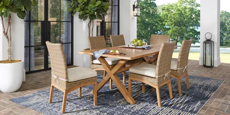 Photo of a wicker and teak dining set on a patio