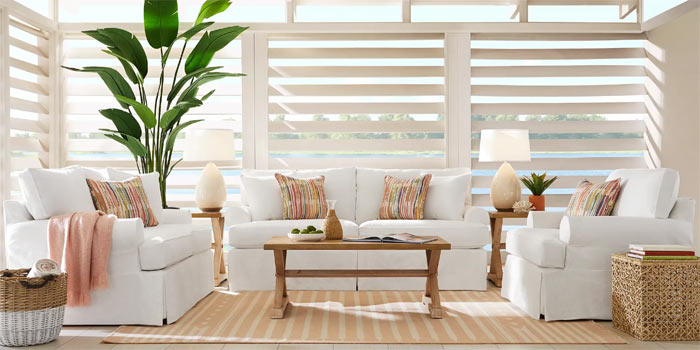 photo of ivory sofa set and wood tables in a sunroom