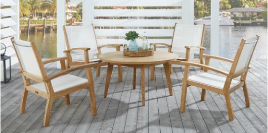 Tan teak outdoor chat set with white wooden wind block