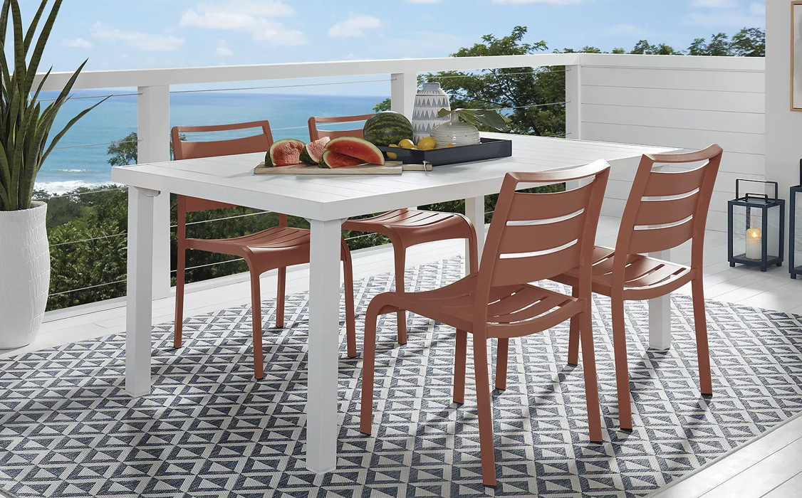 white metal dining table with coral chairs
