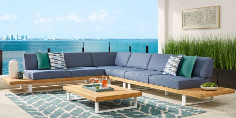 Photo of wood and metal outdoor sectional with blue cushions