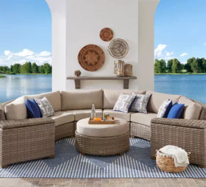 Photo of curved wicker patio sofa and ottoman