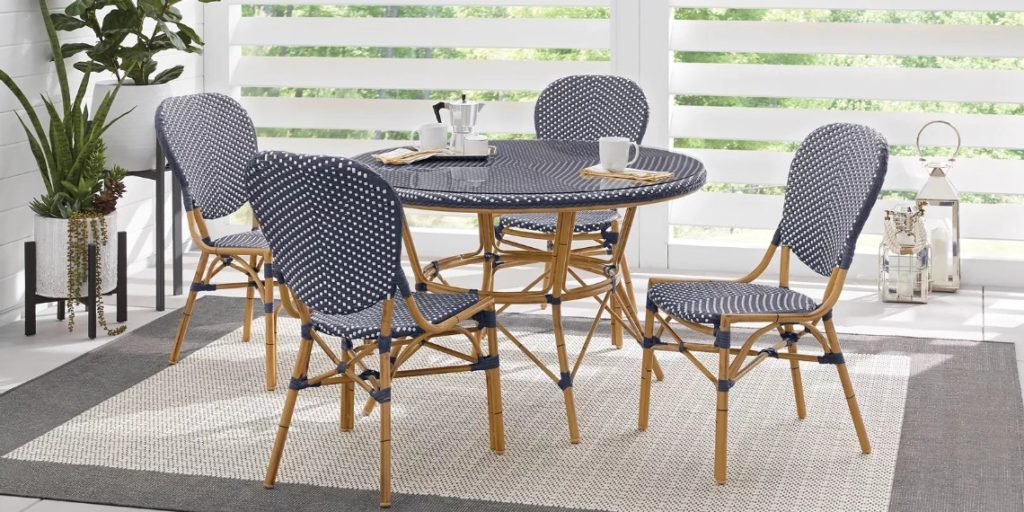 Blue 5 piece dining set next to white slatted screen