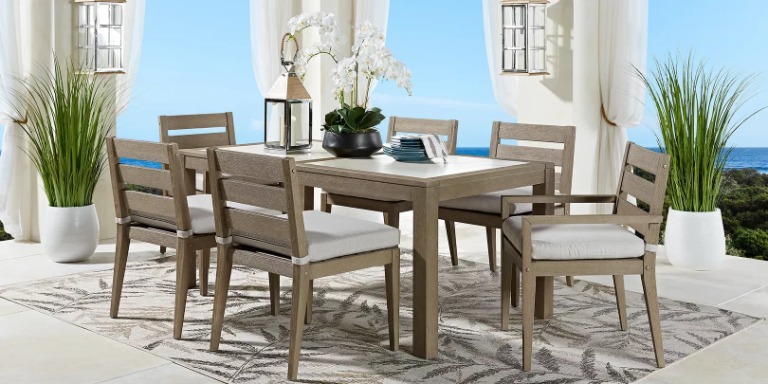 photo of brown dining table and chairs with ivory cushions