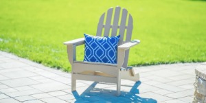 White POLYWOOD Adirondack chair with blue pillow