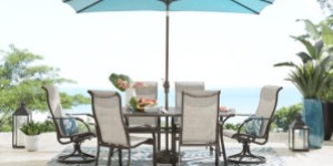 Image of a white and brown outdoor dining set with a blue umbrella